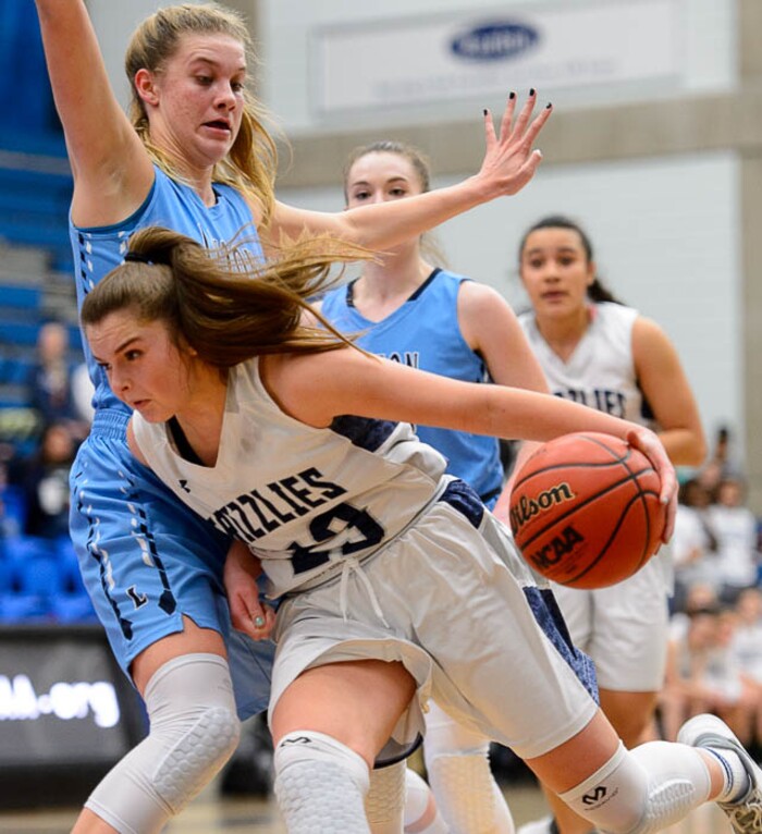 (Trent Nelson | The Salt Lake Tribune)  Copper Hills's Breaunna Gillen (23) drives around Layton's Gracey Criswell (21) as Layton faces Copper Hills in the 6A High School Girls' Basketball Tournament at SLCC in Taylorsville, Thursday Feb. 22, 2018.