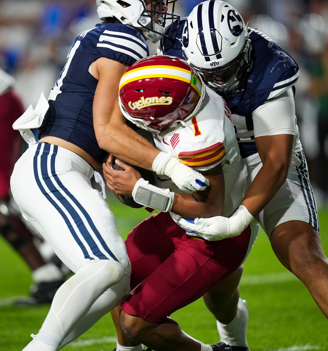 (Bethany Baker  |  The Salt Lake Tribune) BYU Cougars linebacker Jake Clifton (left) and BYU Cougars defensive end Anisi Purcell (right) sack Iowa State Cyclones quarterback Jaylen Raynor (1) during the game between the BYU Cougars and the Iowa State Cyclones in Provo on Friday, Oct. 9, 2026.