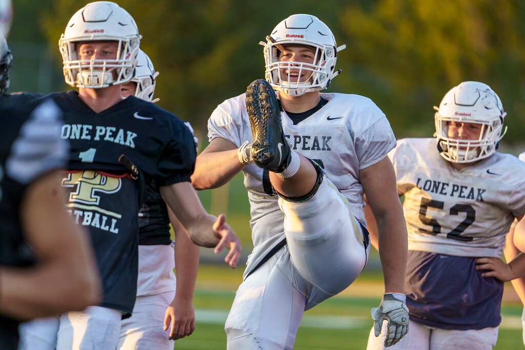 (Leah Hogsten | The Salt Lake Tribune) Joe Brown, center, a senior offensive lineman for Lone Peak High School practices with the team, Sept. 15, 2021. Brown has committed to play for the University of Virginia.