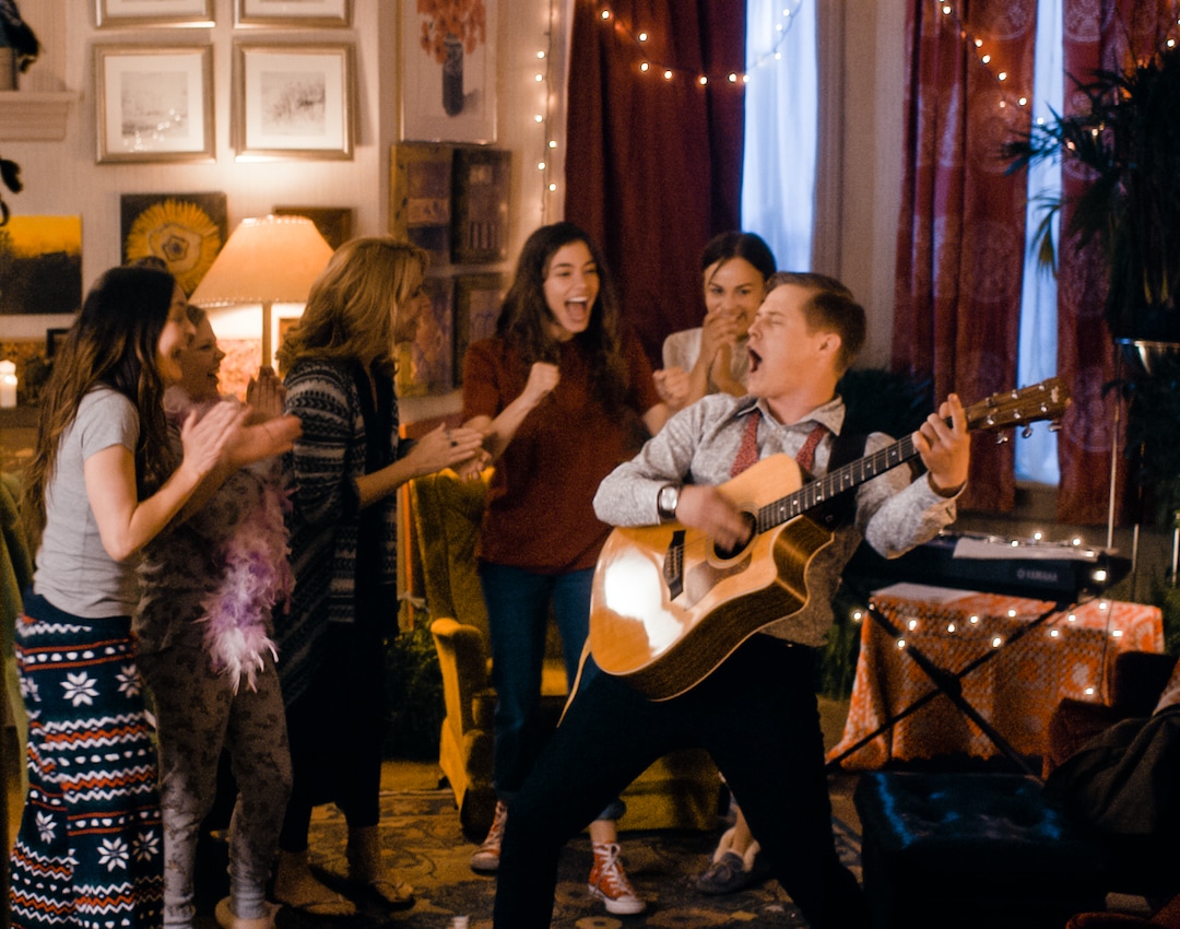 (Photo courtesy Pinnacle Peak Pictures) Laurie (Lucas Grabeel, right) performs for the March women — Meg (Melanie Stone), Amy (Elise Jones), Marmee (Lea Thompson), Jo (Sarah Davenport) and Beth (Allie Jennings), from left — in director Clare Niederpruem's modern-day adaptation of Louisa May Alcott's "Little Women."