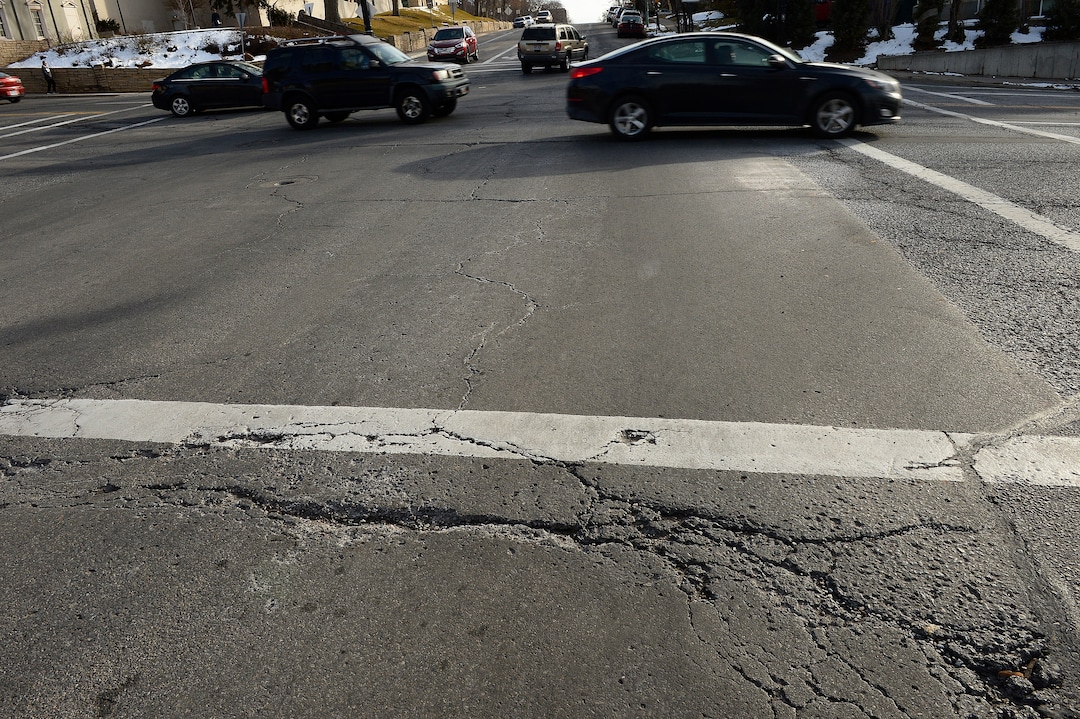 (Scott Sommerdorf   |  The Salt Lake Tribune)   
A section of the damaged road on 100 South and the intersection of University in Salt Lake City, Wednesday, January 24, 2018.