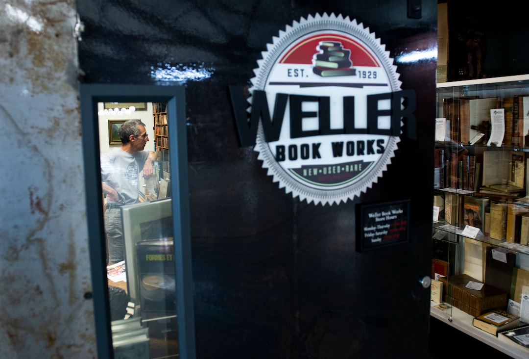 (Leah Hogsten  |  The Salt Lake Tribune)  Tony Weller talks with a customer in the rare book section of Weller Book Works, August 7, 2019. Weller Book Works — formerly Zion Bookstore and Sam Weller's Books — is celebrating its 90th year.