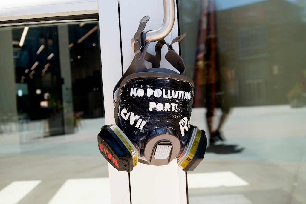 (Jeremy Harmon | The Salt Lake Tribune) A gas mask hangs on the door at Colmena Group's office in Salt Lake City on Wednesday, June 19, 2019, following a protest of the inland port. Activists say Colmena Group owns property where the proposed port is to be built.
