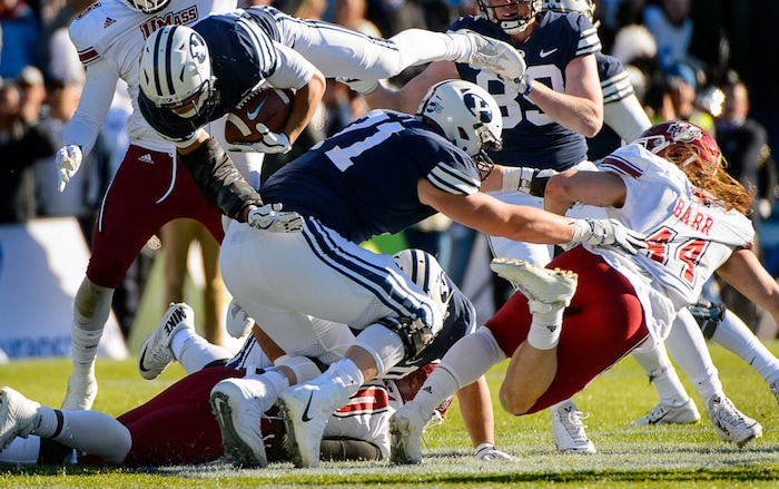(Trent Nelson | The Salt Lake Tribune)  Brigham Young Cougars running back KJ Hall (24) dives for yardage as BYU hosts the University of Massachusetts, NCAA football in Provo, Saturday November 18, 2017.