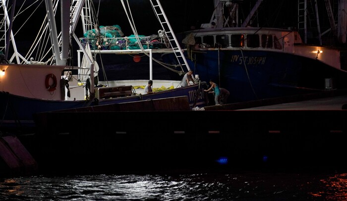 Crew members of a shrimp boat called the Sea Lion V prepare as they wait for Hurricane Laura to make landfall, Wednesday, Aug. 26, 2020, in Port Arthur, Texas. (AP Photo/Eric Gay)