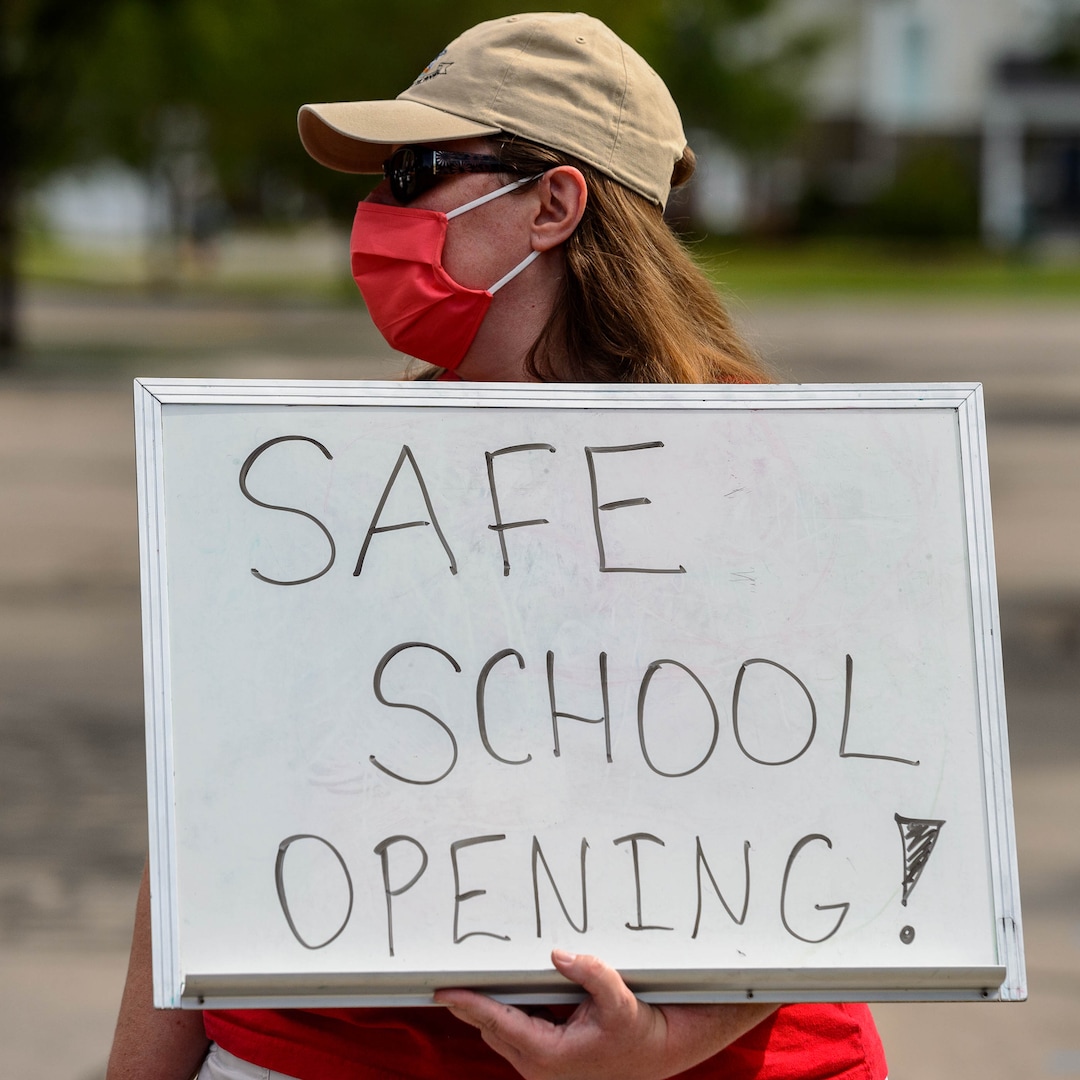 (Trent Nelson  |  The Salt Lake Tribune) Elizabeth Pickett, a teacher at Westvale Elementary School, joined other teachers and parents holding signs calling for a safe plan on reopening schools prior to a Jordan School District board meeting in Riverton on Tuesday, July 28, 2020.