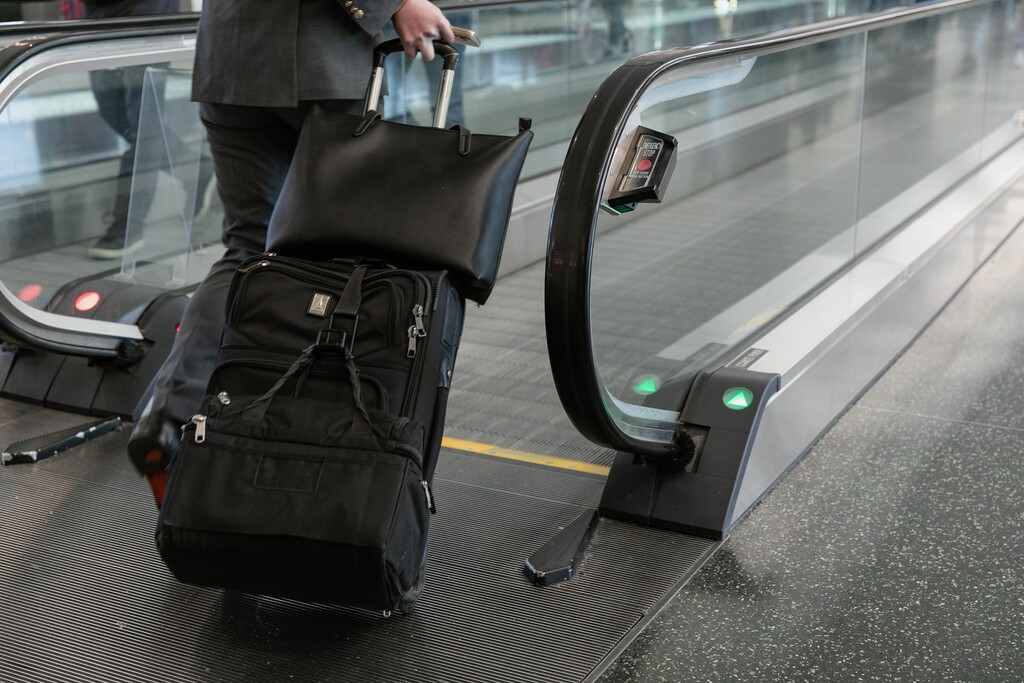(Rachel Rydalch | The Salt Lake Tribune) A man uses the moving walkway at the Salt Lake International Airport on Thursday, Jan. 27, 2022. A Utah woman is facing federal charges after allegedly selling Salt Lake City International Airport travelers falsified COVID-19 tests.