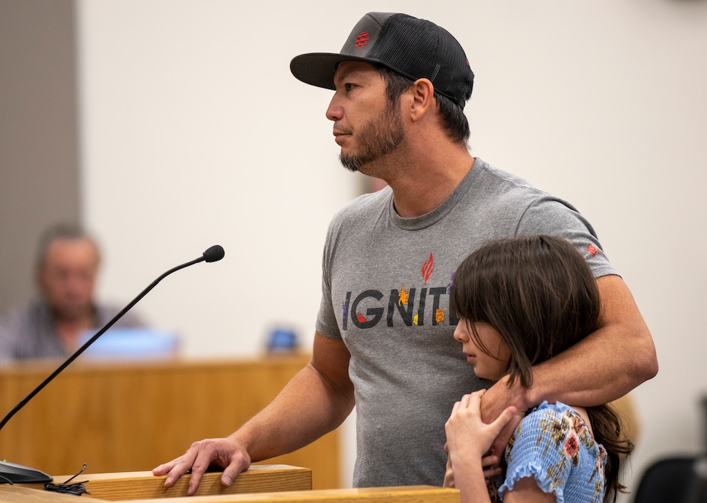 (Rick Egan | The Salt Lake Tribune) Jesse Sirivanchai speaks at the Jordan School District board meeting with 11-year-old Alison by his side, on Tuesday, Sept. 26, 2023.