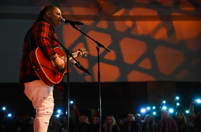 (Francisco Kjolseth  |  The Salt Lake Tribune)  Kellin Rosillo performs an original song as people light up their phones and cheer her on during Utah State University's very first drag queen show. 