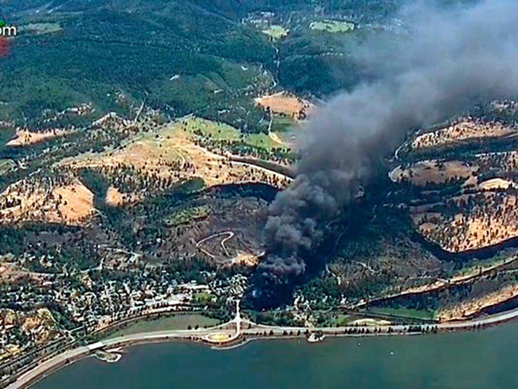 (KGW-TV | The Associated Press) In this June 3, 2016, file image, from video provided by KGW-TV, smoke billows from a Union Pacific train that derailed near Mosier, Ore., in the scenic Columbia River Gorge. The Trump administration vastly understated the potential benefits of installing more advanced brakes on trains that haul explosive fuels when it cancelled a requirement for railroads to begin using the equipment. A government analysis used by the administration to justify the cancellation omitted up to $117 million in potential reduced damages from using electronic brakes. Department of Transportation officials acknowledged the error after it was discovered by The Associated Press during a review of federal documents but said it would not have changed their decision.