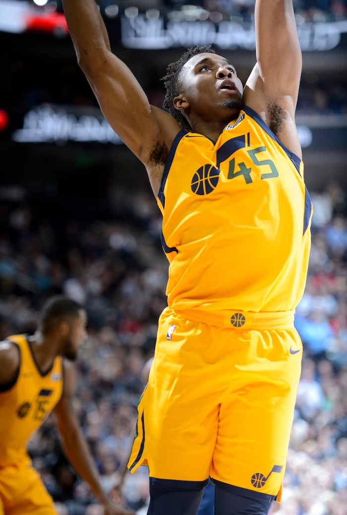 (Steve Griffin  |  The Salt Lake Tribune) Utah Jazz guard Donovan Mitchell (45) stretches for a rebound during the Utah Jazz versus Denver Nuggets NBA basketball game at Vivint Smart Home Arena  in Salt Lake City Tuesday November 28, 2017.