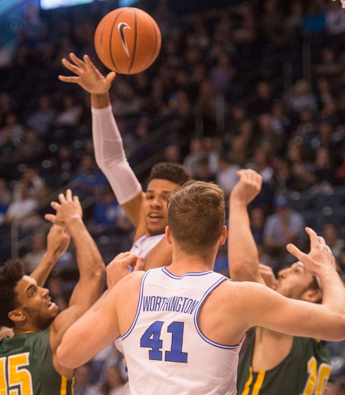 (Rick Egan  |  The Salt Lake Tribune)     Brigham Young Cougars forward Yoeli Childs (23) tosses a pass to Brigham Young Cougars forward Luke Worthington (41) in basketball action at the Marriott Center, Saturday, February 10, 2018.