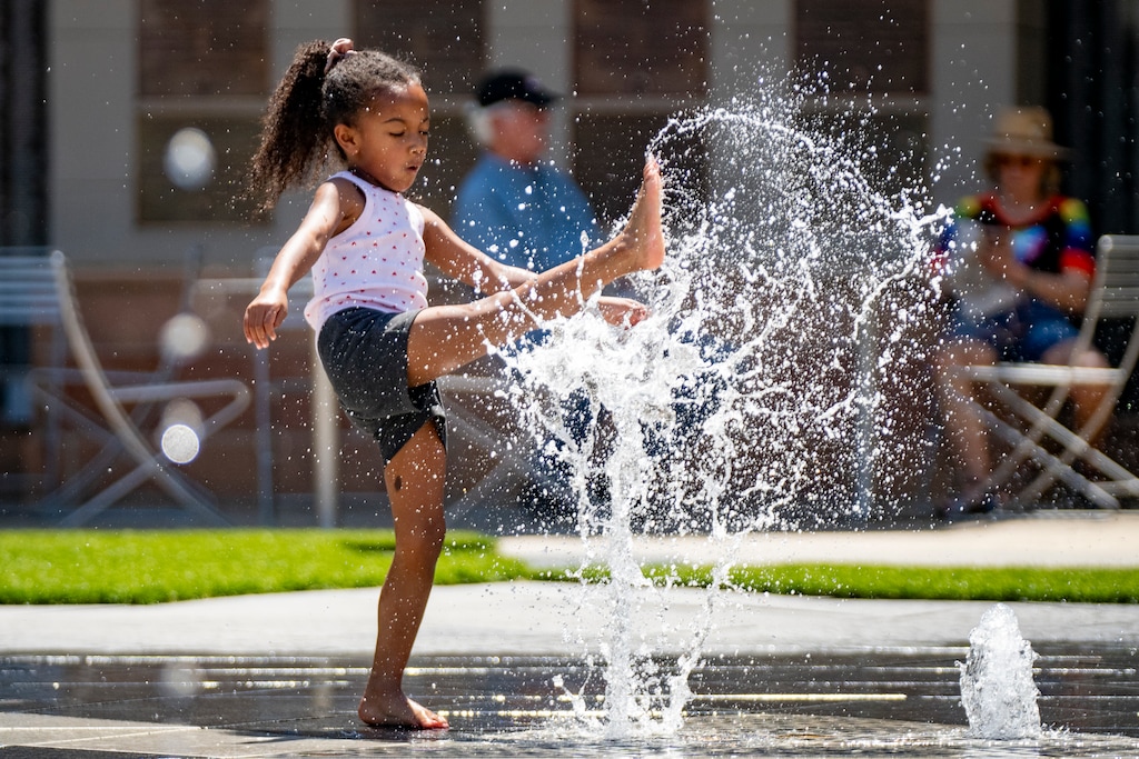 (Rick Egan | The Salt Lake Tribune) Jordyn Woods plays in the fountain during the Juneteenth celebration at The Gateway on Friday, June 19, 2026.
