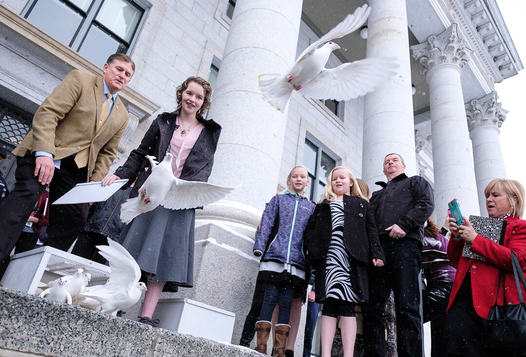 (Francisco Kjolseth  |  The Salt Lake Tribune)  Rep. Val Potter, R-Logan, is joined by Deserae Turner as they release 25 doves on the front steps of the Utah Capitol on Tuesday, Feb. 20, 2018, representing the number of attempts for every suicide death. Turner, a Utah teenage girl who survived being shot in the head by two boys was there to bring attention to bullying and its connection to suicide. 