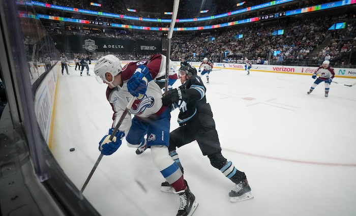 (Bethany Baker | The Salt Lake Tribune) Utah Hockey Club center Clayton Keller (9) and Colorado Avalanche defenseman Cale Makar (8) vie for the puck during the game between the Utah Hockey Club and the Colorado Avalanche at the Delta Center in Salt Lake City on Thursday, Oct. 24, 2024.