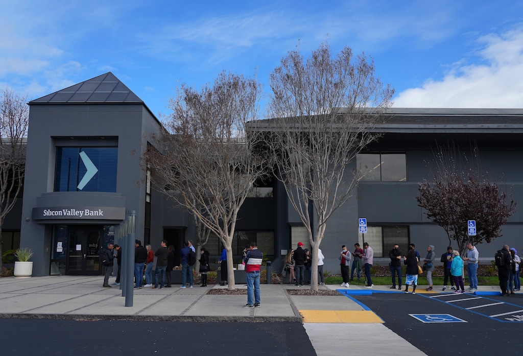 (Jim Wilson | The New York Times) A line of clients outside the entrance to Silicon Valley Bank's headquarters in Santa Clara, Calif., March 13, 2023. The FDIC and other entities will protect most people’s bank and brokerage balances; but it’s as good a time as any for consumers to create other backstops.