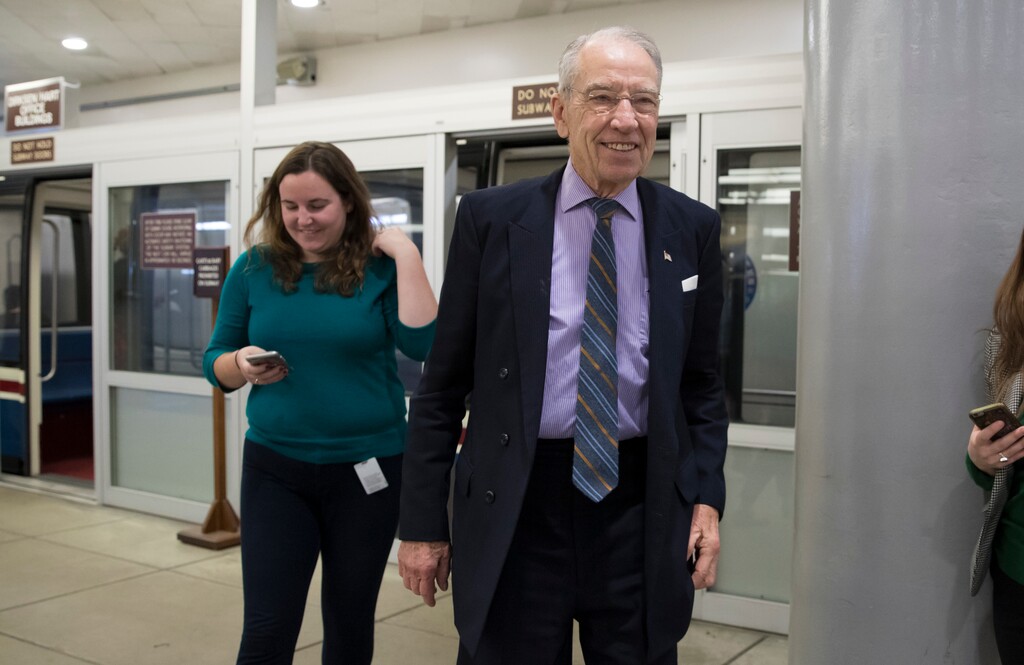 Senate Judiciary Committee Chairman Chuck Grassley, R-Iowa, foreground, who also sits on the tax-writing Senate Finance Committee, heads to the Senate floor for votes on Capitol Hill in Washington, Monday, Nov. 27, 2017. President Donald Trump and Senate Republicans are scrambling to change a Republican tax bill in an effort to win over holdout GOP senators and pass a tax package by the end of the year. (AP Photo/J. Scott Applewhite)