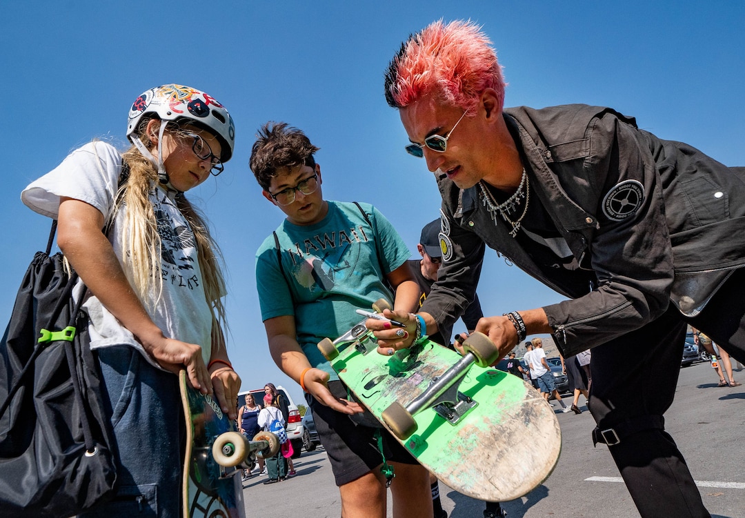 (Francisco Kjolseth | The Salt Lake Tribune) Veteran skater David Loy, right, signs the decks of Jameson Johnston, 13, left, and Jack Petersen, 12, as they check out the events for the Street League Skateboarding at the Utah State Fairpark in Salt Lake City highlighting the world’s best skaters on Saturday, Aug. 28, 2021.