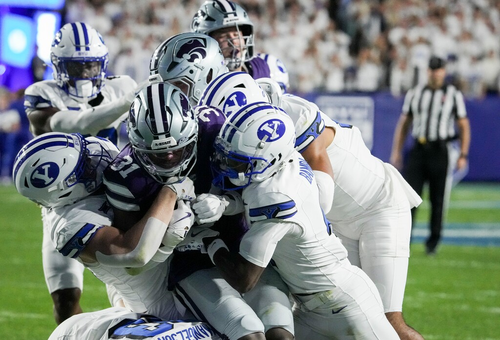 (Bethany Baker | The Salt Lake Tribune) Kansas State Wildcats running back DJ Giddens (31) is tackled by the Brigham Young Cougars during the game between the Brigham Young Cougars and the Kansas State Wildcats in Provo on Saturday, Sept. 21, 2024.