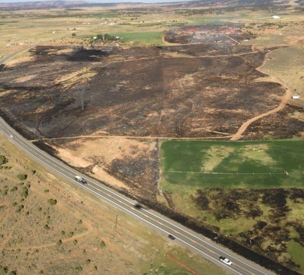 (Photo courtesy Utahfireinfo.gov) The wild land blaze dubbed the 6400 Fire smolders Aug. 9, 2020, along U.S. Highway 40 near Fruitland, Utah.