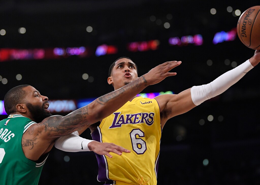 Los Angeles Lakers guard Jordan Clarkson, right, shoots as Boston Celtics forward Marcus Morris defends during the first half of an NBA basketball game Tuesday, Jan. 23, 2018, in Los Angeles. (AP Photo/Mark J. Terrill)