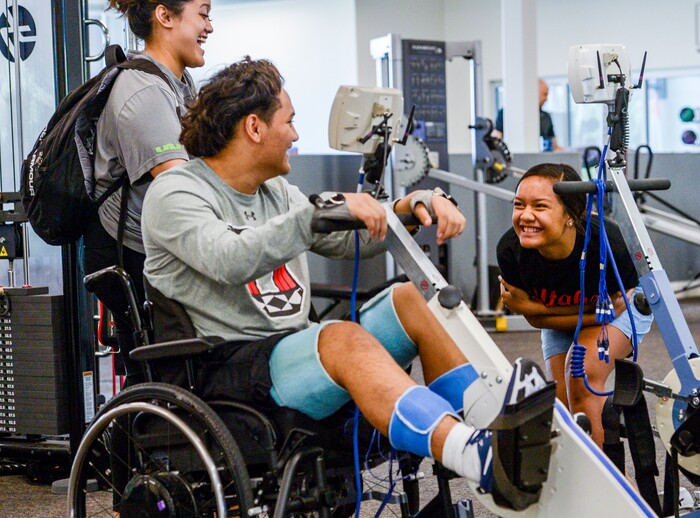 (Leah Hogsten  |  The Salt Lake Tribune) l-r Justice Afatasi and Stak Afatasi laugh at the antics of their sister Amaya Afatasi during Stak’s Neuroworx theraphy session on Friday, June 21, 2019. Audrick “Stak” Afatasi is fighting to regain movement in his lower body after being paralyzed at a trampoline park on March 15, 2019.
