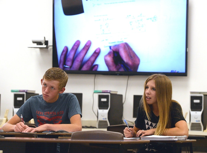 (Al Hartmann | The Salt Lake Tribune) Park Valley School students Derek Kunzler and Brynlee Larsen follow along in math instruction via an interactive video conference with a teacher at Bear River High School in Garland, about 60 miles away.