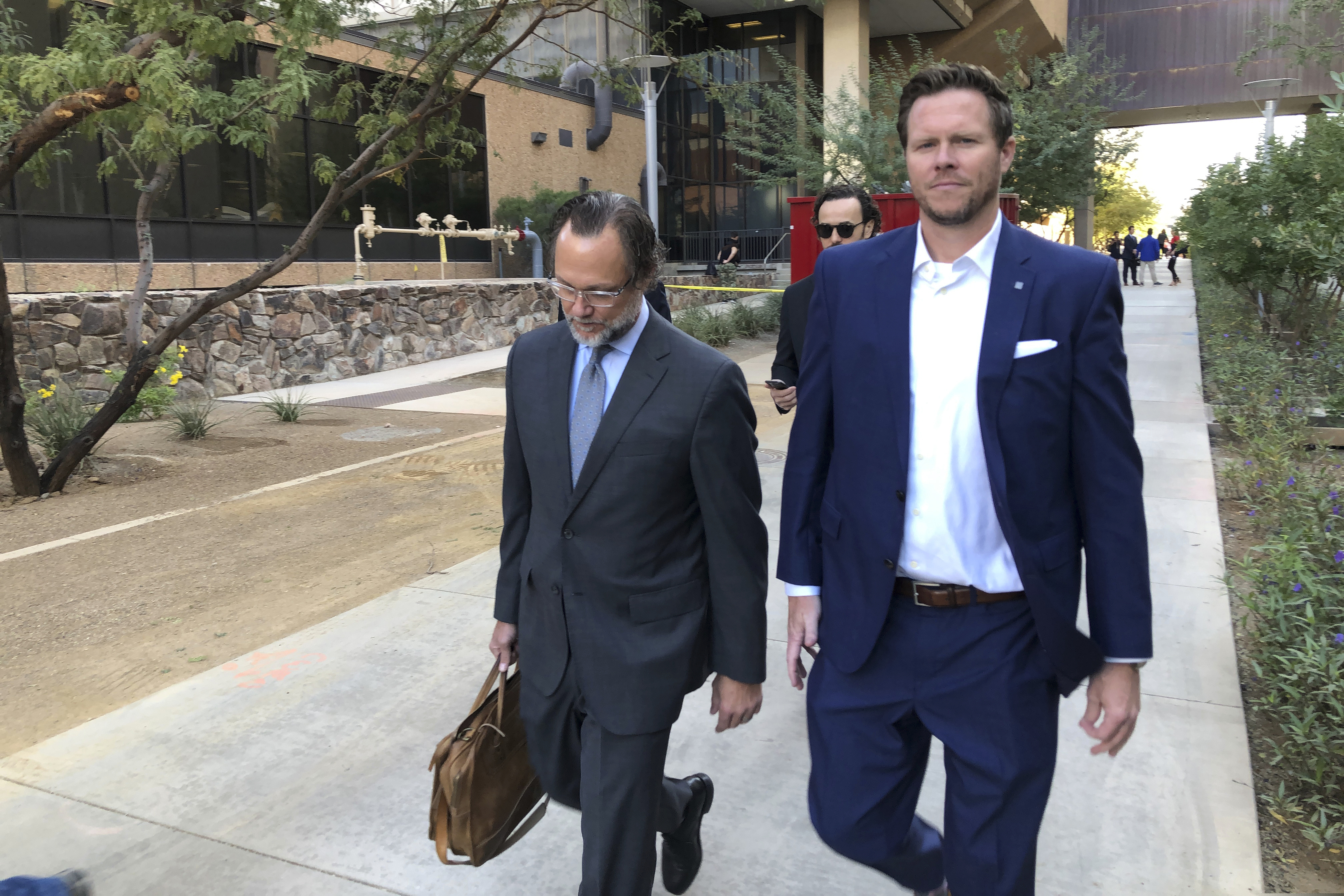 FILE – In this Nov. 5, 2019, file photo, is then-Maricopa County Assessor Paul Petersen, right, and his attorney, Kurt Altman, as they leave a court hearing in Phoenix. Petersen, who has acknowledged running an illegal adoption scheme in Arizona, Arkansas and Utah, was sentenced in Utah on Wednesday, April 21, 2021. (AP Photo/Jacques Billeaud, File)