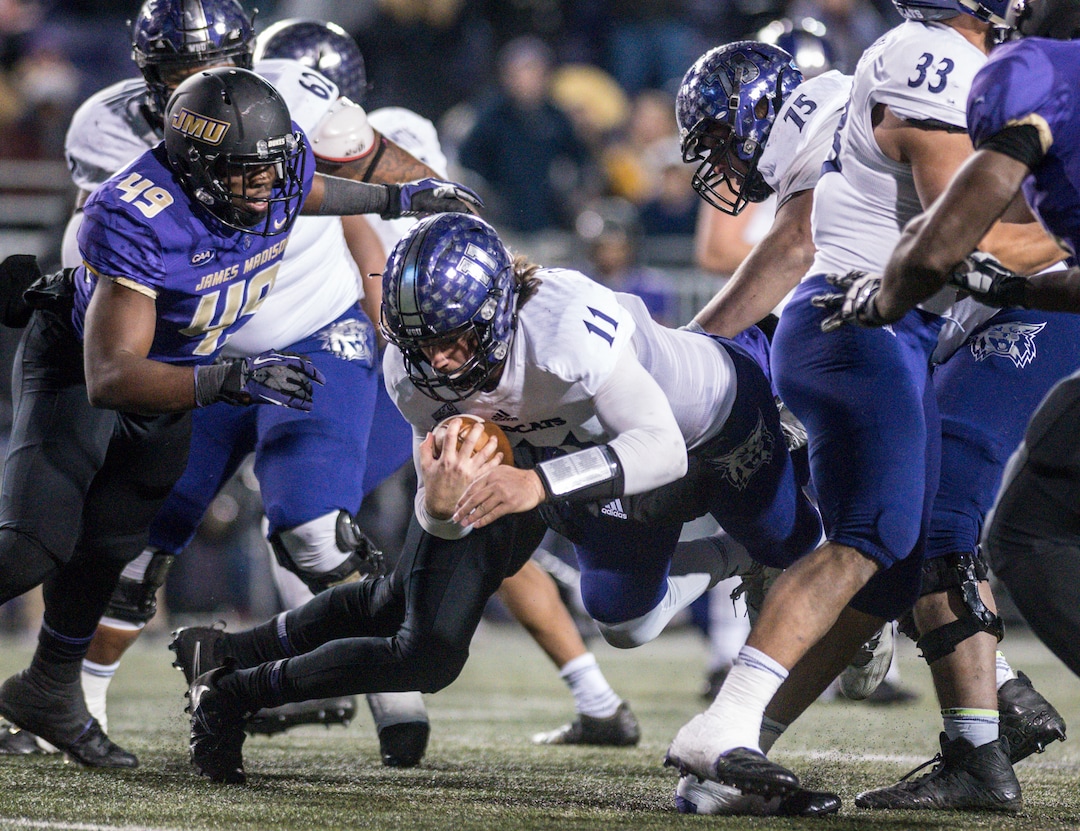 Weber State quarterback Stefan Cantwell (11) dives through the James Madison line during the first half of an NCAA college football game in the quarterfinals of the FCS playoffs Friday, Dec. 8, 2017, in Harrisonburg, Va. (Daniel Lin/Daily News-Record via AP)
