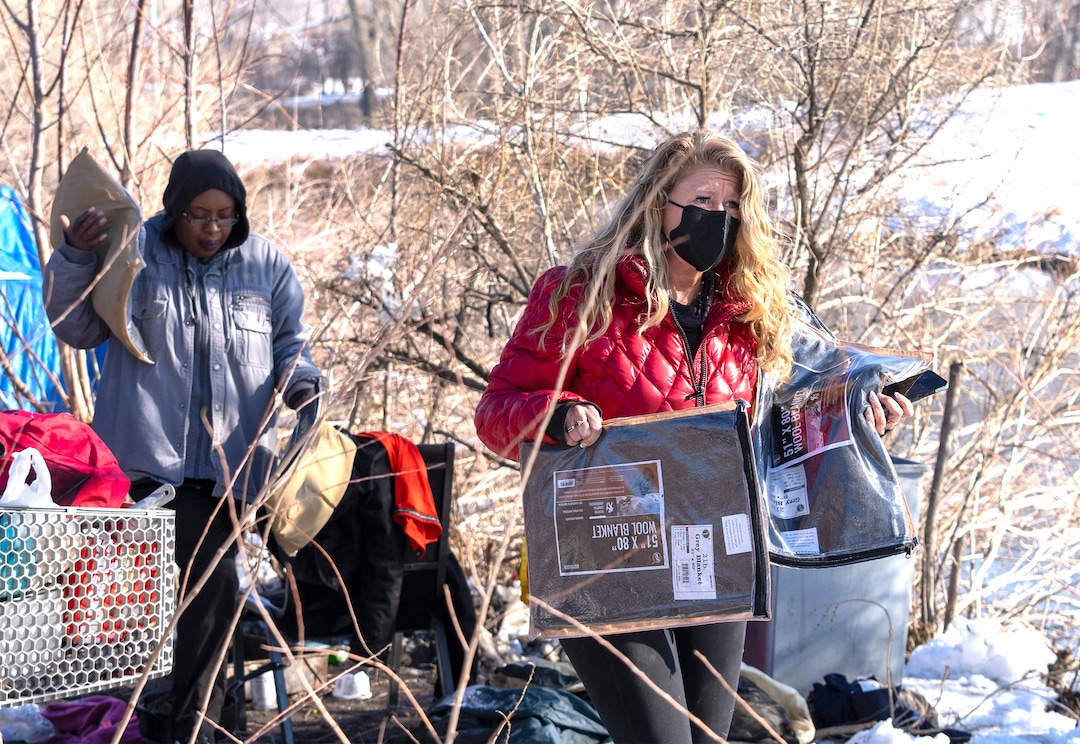 (Rick Egan | The Salt Lake Tribune) Ty Bellamy with Black Lives for Humanity, and Carin Crowe from Habitat for Humanity distribute wool blankets donated by the Sikh community, to people in camps in Salt Lake, to help the unsheltered stay warm,  Thursday, December 23, 2021.