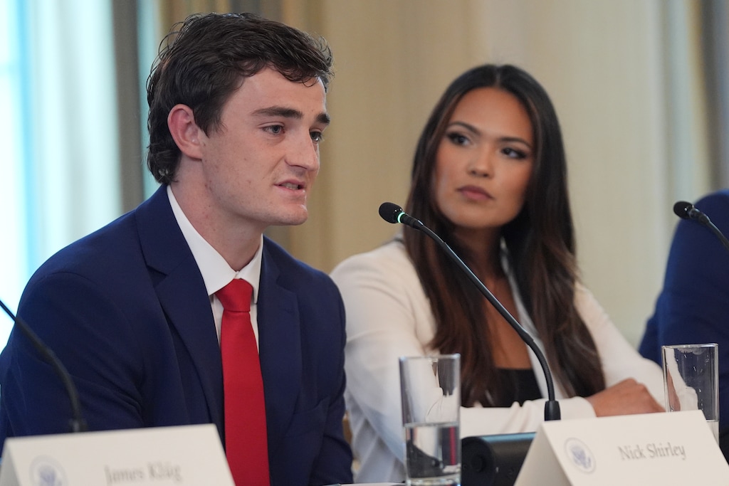 (Evan Vucci | AP) Nick Shirley speaks during a roundtable meeting with President Donald Trump on antifa in the State Dining Room at the White House, Wednesday, Oct. 8, 2025, in Washington, as Savanah Hernandez listens.