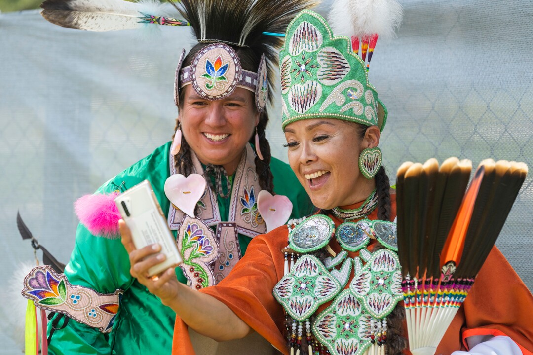 (Rick Egan | The Salt Lake Tribune) Devan Kicknosway, from Ontario Canada, and Marian Mike from White Mesa, AZ do an instagram post, at the Native American celebration and Powwow at Liberty Park, on Friday, July 23, 2021.
