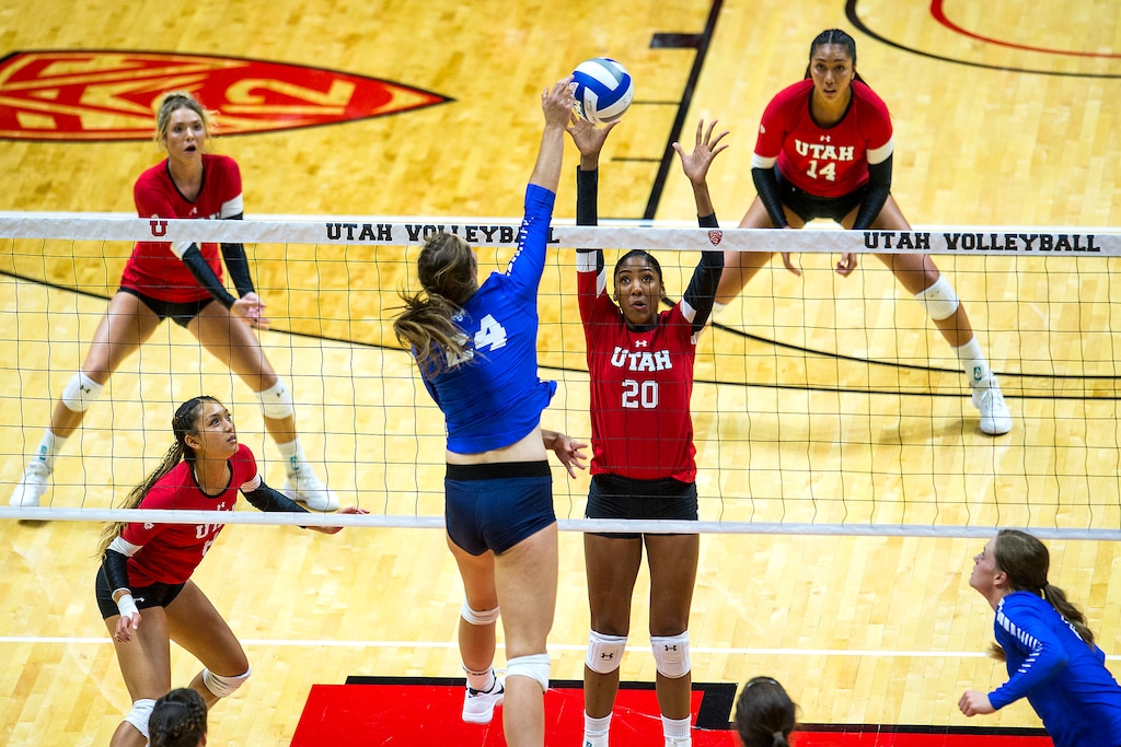 (Chris Detrick  |  The Salt Lake Tribune)  Brigham Young's Kennedy Redding (24) spikes past Utah's Tawnee Luafalemana (20) during the volleyball match at the Jon M. Huntsman Center Thursday, September 14, 2017. 