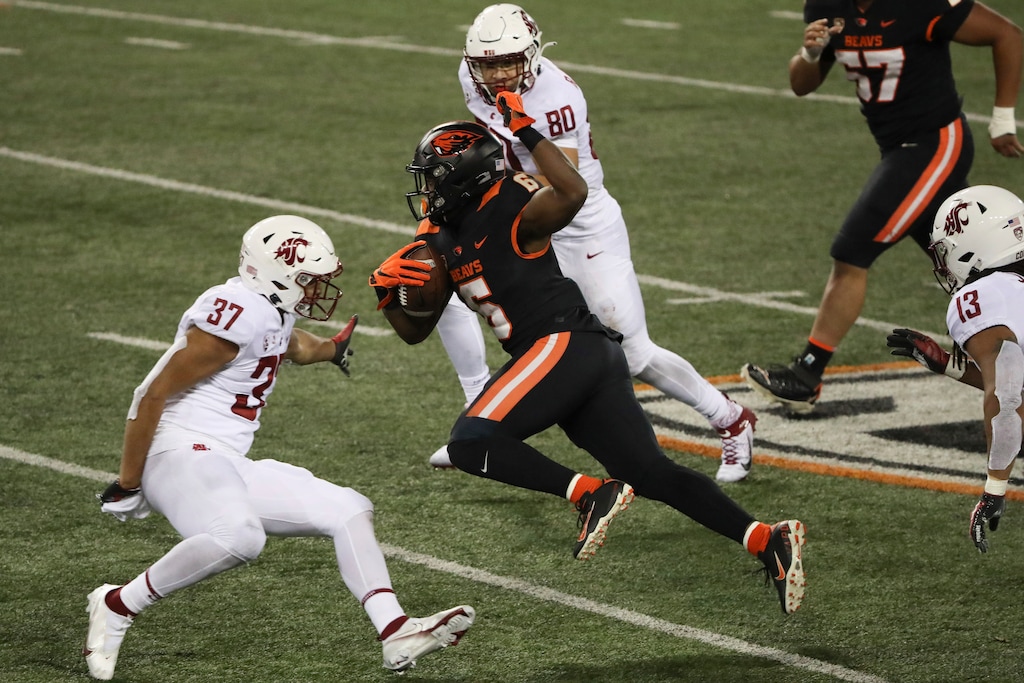 Oregon State running back Jermar Jefferson (6) weaves past Washington State linebacker Justus Rogers (37) and linebacker Brennan Jackson (80) during the second half of an NCAA college football game in Corvallis, Ore., Saturday, Nov. 7, 2020. Washington State won 38-28. (AP Photo/Amanda Loman)