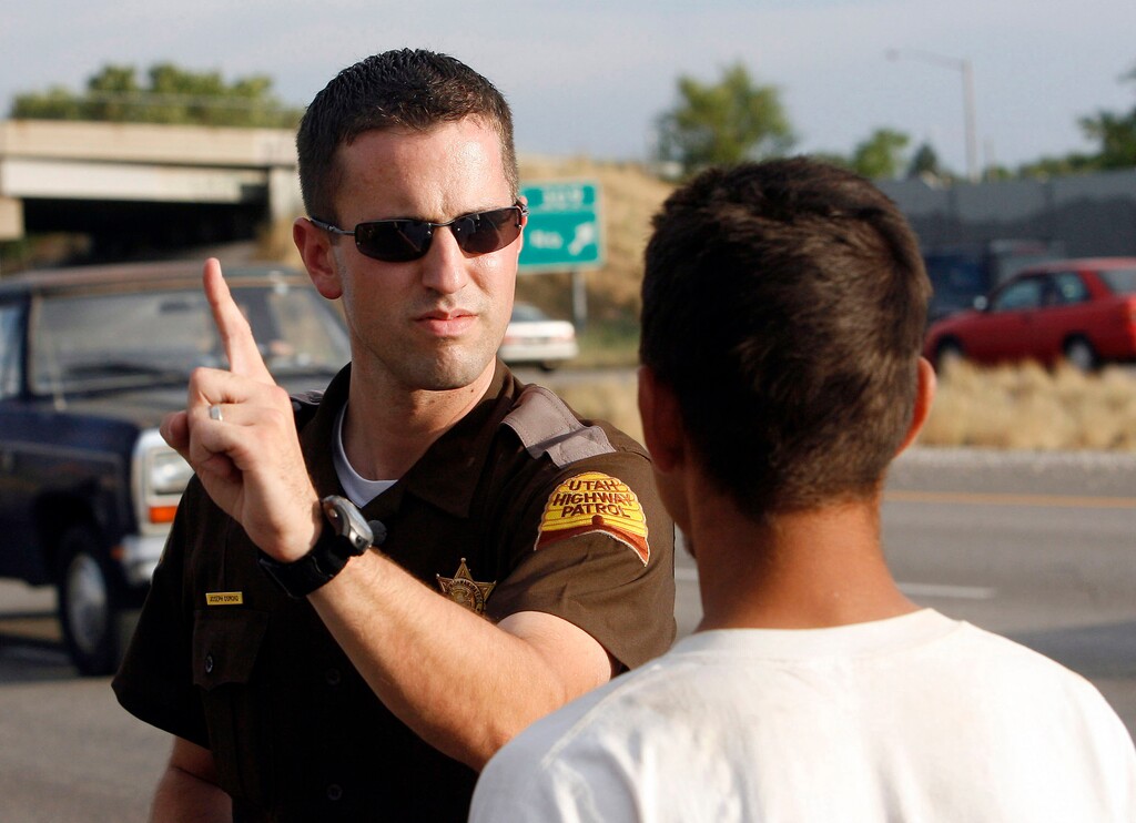 (Al Hartmann  |  Tribune file photo)  UHP trooper Joseph Osmond gives a field sobriety test to a driver on I-15.