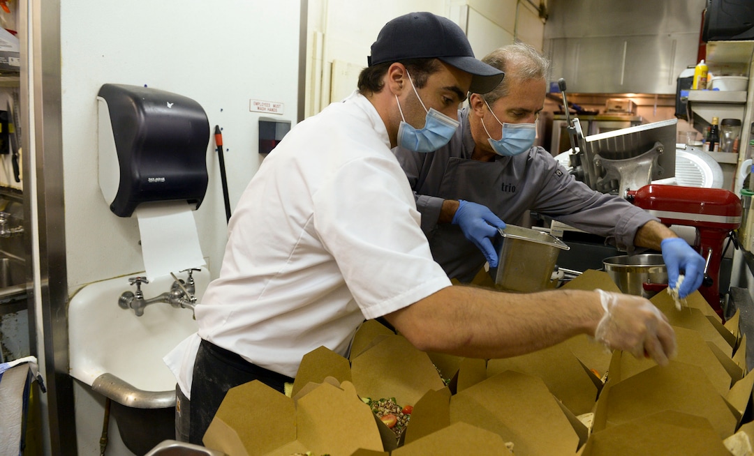 (Leah Hogsten  |  The Salt Lake Tribune) Trio restaurant owner Mikel Trapp and executive chef Lloyd Kianfar prepare Summer Grain Salads to feed frontline workers June 3, 2020. Since March, the Helping Heroes program, launched by Utah restaurant food supplier, Nicholas & Co., has been taking food originally planned for restaurants and using it to feed frontline COVID-19 workers across the Wasatch Front.