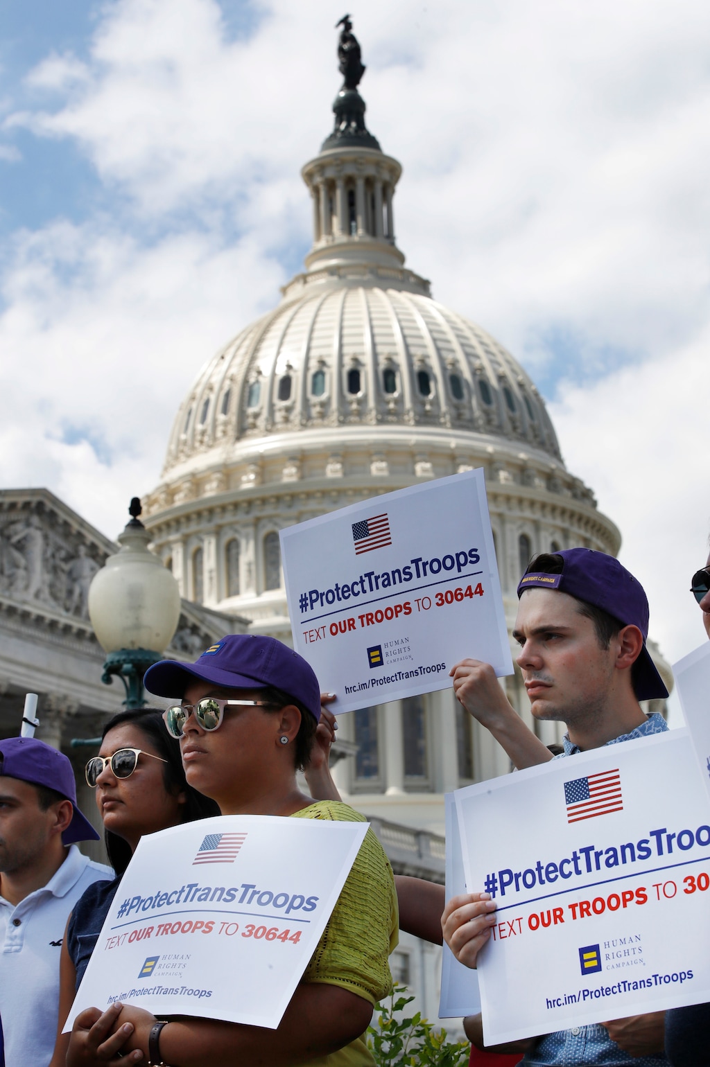Steven McCarty, right, and others, attends an event in support of transgender members of the military, Wednesday, July 26, 2017, on Capitol Hill in Washington, after President Donald Trump said he wants transgender people barred from serving in the U.S. military "in any capacity," citing "tremendous medical costs and disruption." (AP Photo/Jacquelyn Martin)