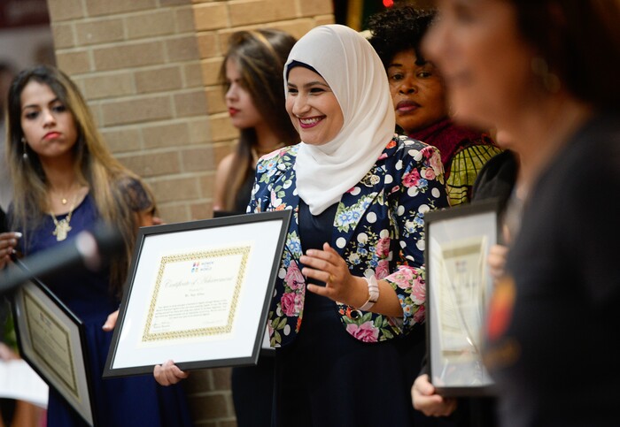 (Francisco Kjolseth  |  The Salt Lake Tribune)  Saja Abbas of Iraq joins 24 other refugee women being awarded certificates of achievement by the Women of the World 8th annual award ceremony at the Salt Lake County building in Salt Lake City on Saturday, Dec. 8, 2018, as a celebration of successes including educational, service, and employment milestones by refugee women.