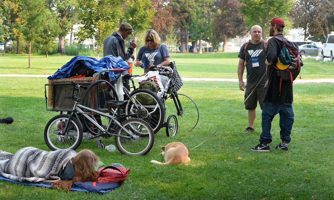 (Scott Sommerdorf   |  The Salt Lake Tribune)   Machele Nieto, left, and Sean Spalding, of the Volunteers of America, hands out some supplies to a homeless man in Fairmont Park, Wednesday, September 6, 2017.