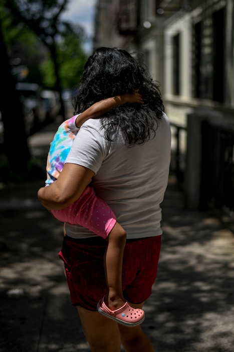 (Desiree Rios | The New York Times)

A mother holds her daughter in New York, June 19, 2020. "What seems clear is that the real reason many on the right oppose helping children is that they fear that such help might make low-income families less desperate," writes New York Times columnist Paul Krugman.