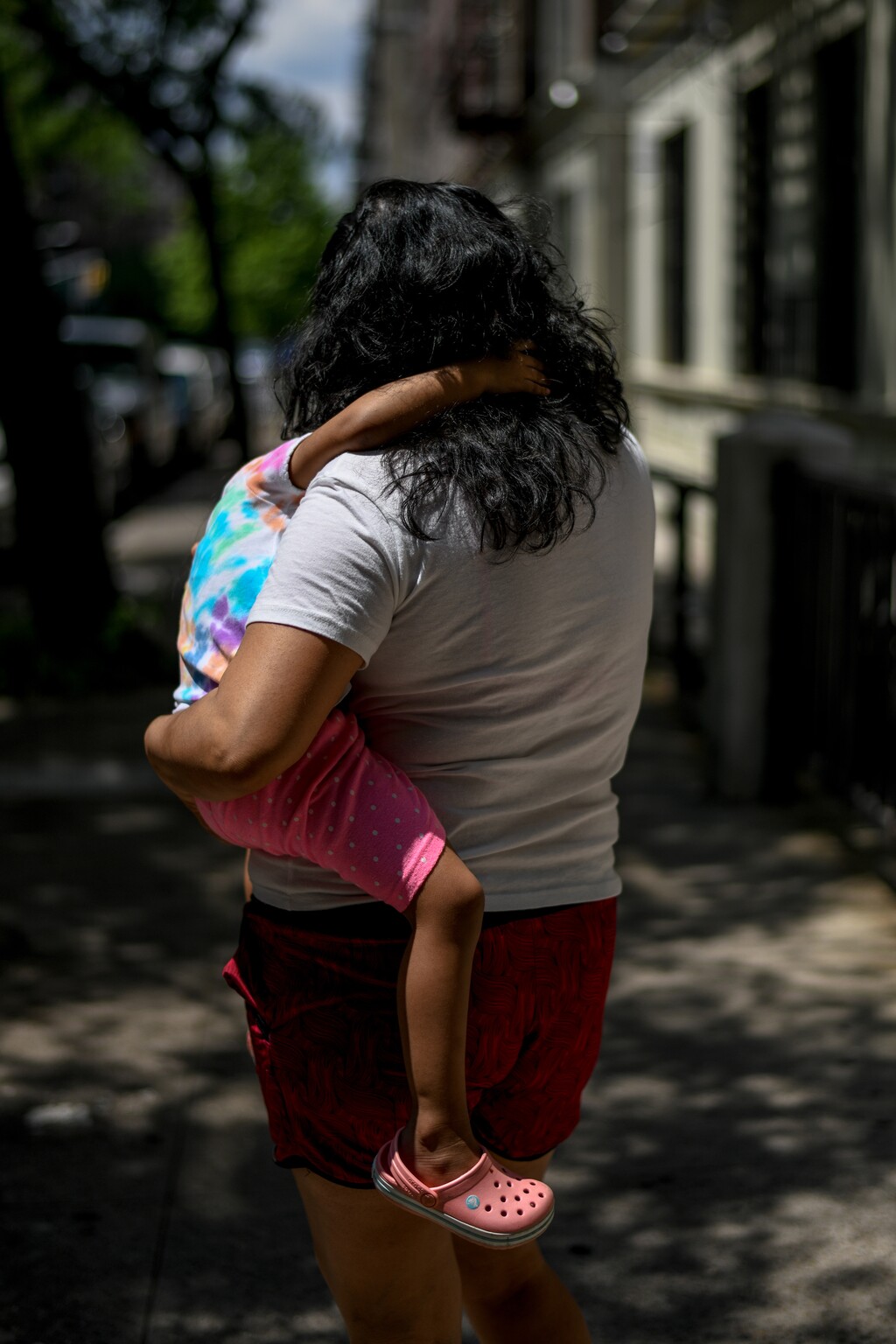 (Desiree Rios | The New York Times)
A mother holds her daughter in New York, June 19, 2020. "What seems clear is that the real reason many on the right oppose helping children is that they fear that such help might make low-income families less desperate," writes New York Times columnist Paul Krugman.