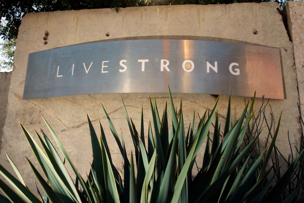 FILE - In this Jan. 13, 2013, file photo, a sign for the Livestrong Foundation is seen at the charity's headquarters in Austin, Texas. The Livestrong cancer charity continued its fundraising and contributions nosedive in 2015 for a third straight year after founder Lance Armstrong's performance-enhancing drug scandal, but foundation officials insist a rebound has already started. (AP Photo/Jack Plunkett, File)