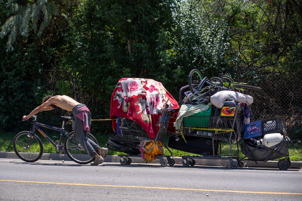 (Rick Egan | The Salt Lake Tribune) A man moves his belongings up 200 South, on Thursday, Aug. 3, 2023.