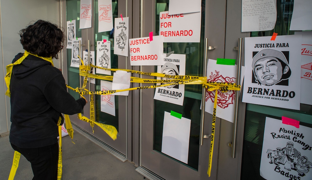 (Rick Egan  |  The Salt Lake Tribune)    Protesters put signs on the doors and rearrange the place tape, at the Salt Lake Public Safety Building, during a Justice for Bernardo protest on Wednesday, June 24, 2020.