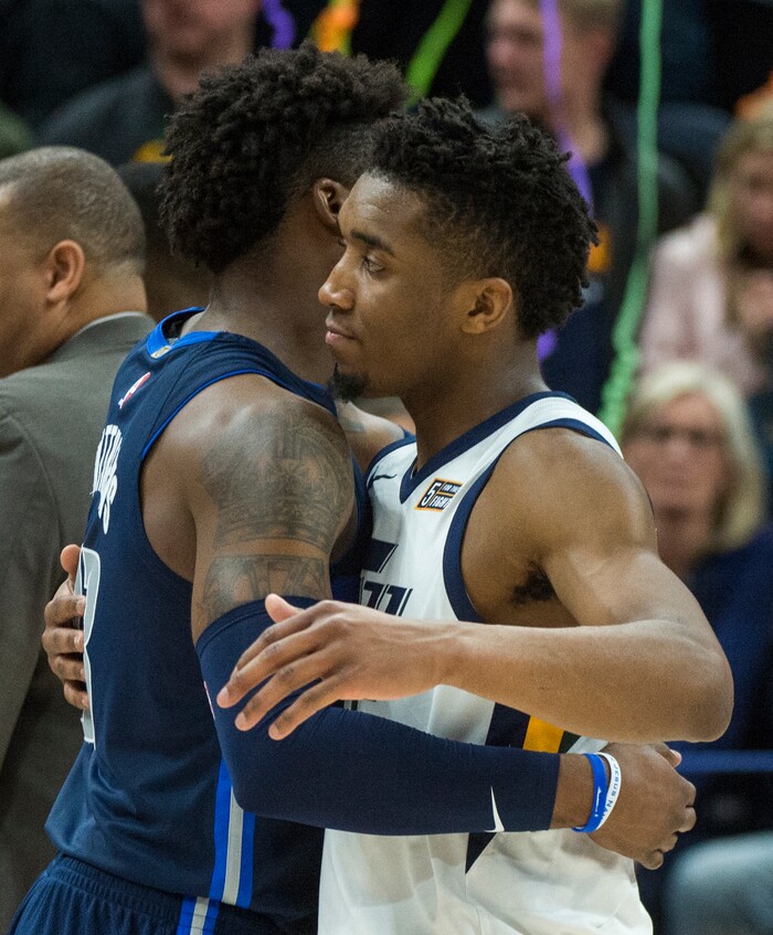 (Rick Egan  |  The Salt Lake Tribune)   Utah Jazz guard Donovan Mitchell (45) hugs Dallas Mavericks guard Wesley Matthews (23) as the Jazz defeat the Mavericks 97-90, in NBA action between Utah Jazz and Dallas Mavericks in Salt Lake City, Saturday, Feb. 24, 2018.