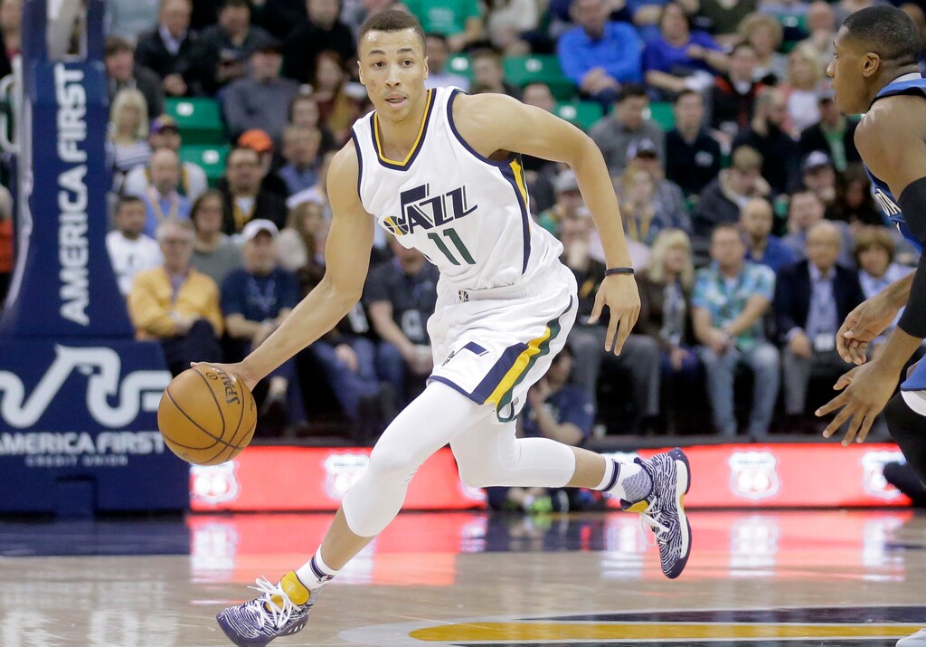 This March 1, 2017 photo shows Utah Jazz guard Dante Exum (11) bringing the ball up against the Minnesota Timberwolves during the second half of an NBA basketball game in Salt Lake City. NBA Summer League rosters are typically full of rookies getting their first taste of the league or other players young in their career trying to catch on with a roster. Exum was the No. 5 overall pick in the 2014 draft and will be running the team, again, as he tries to find a more secure place in the 2017-18 Jazz rotation. (AP Photo/Rick Bowmer)