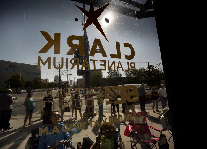 (Scott Sommerdorf | The Salt Lake Tribune) Hundreds of hopeful eclipse-watchers line up outside the Clark Planetarium in hopes of getting eclipse glasses from the gift shop, Thursday, August 17, 2017.