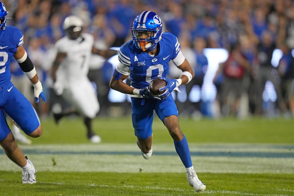 (Rick Bowmer | AP) BYU cornerback Jakob Robinson (0) scores on an interception against Cincinnati during the first half of an NCAA college football game Friday, Sept. 29, 2023, in Provo.
