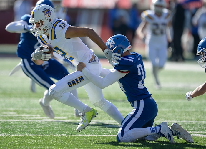 (Francisco Kjolseth  |  The Salt Lake Tribune)  Orem's Puca Nacua tries to push past Dixie's Ethan Emerson in the 4A high school championship game at Rice Eccles Stadium in Salt Lake City, Friday, Nov. 16, 2018.