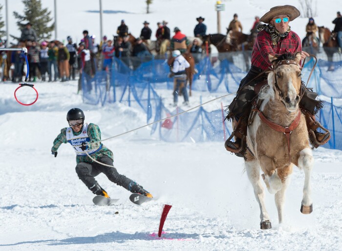 (Rick Egan | The Salt Lake Tribune) Cody Hoover goes for the ring, as Scott Hoover pulls him on Murphy the horse, fo the team "Cruising For a Brusin X2", in the the Skijoring competition at Soldier Hollow Friday. Feb. 22, 2019.